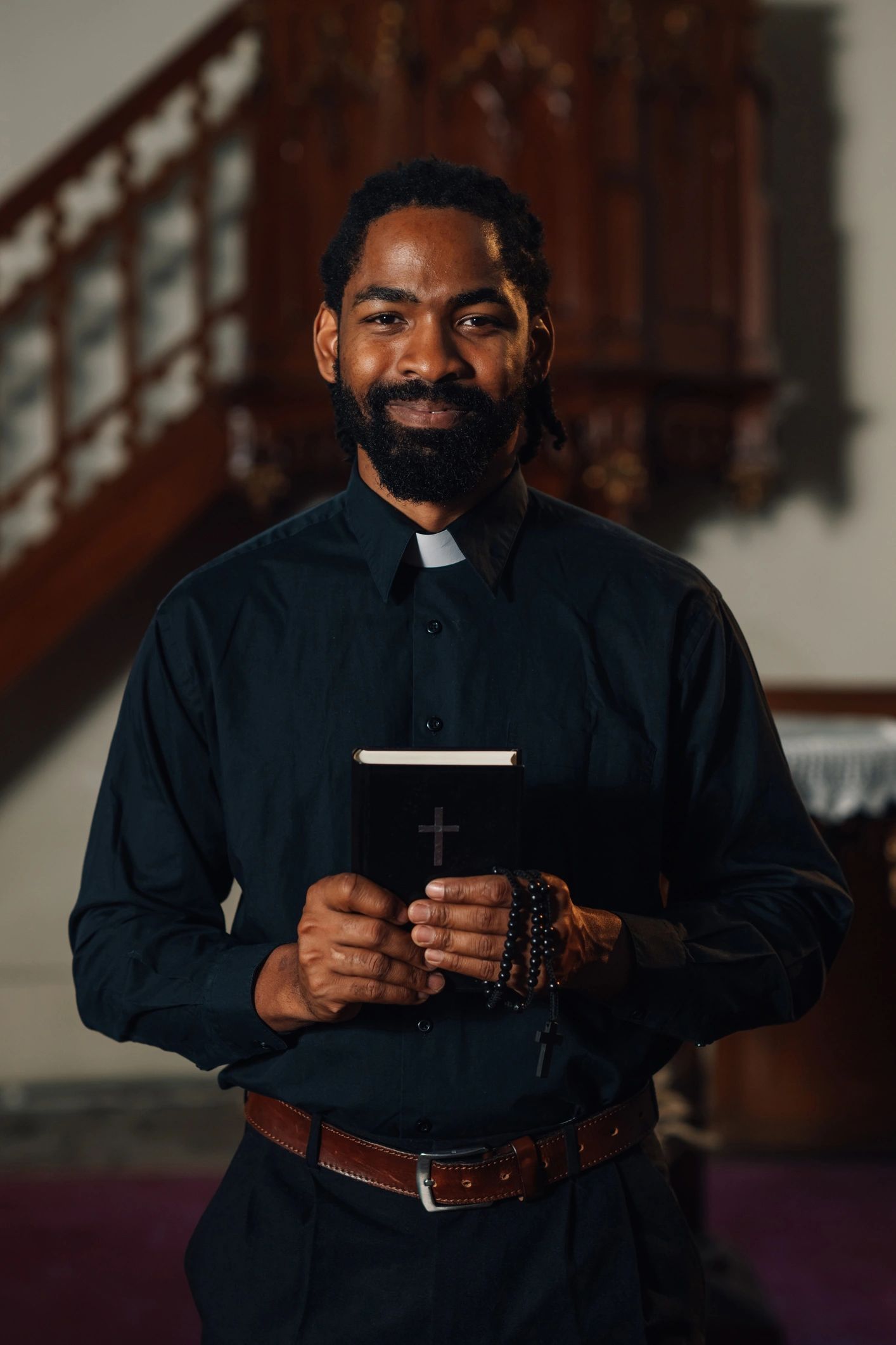 Faith leader holding a Bible in a church